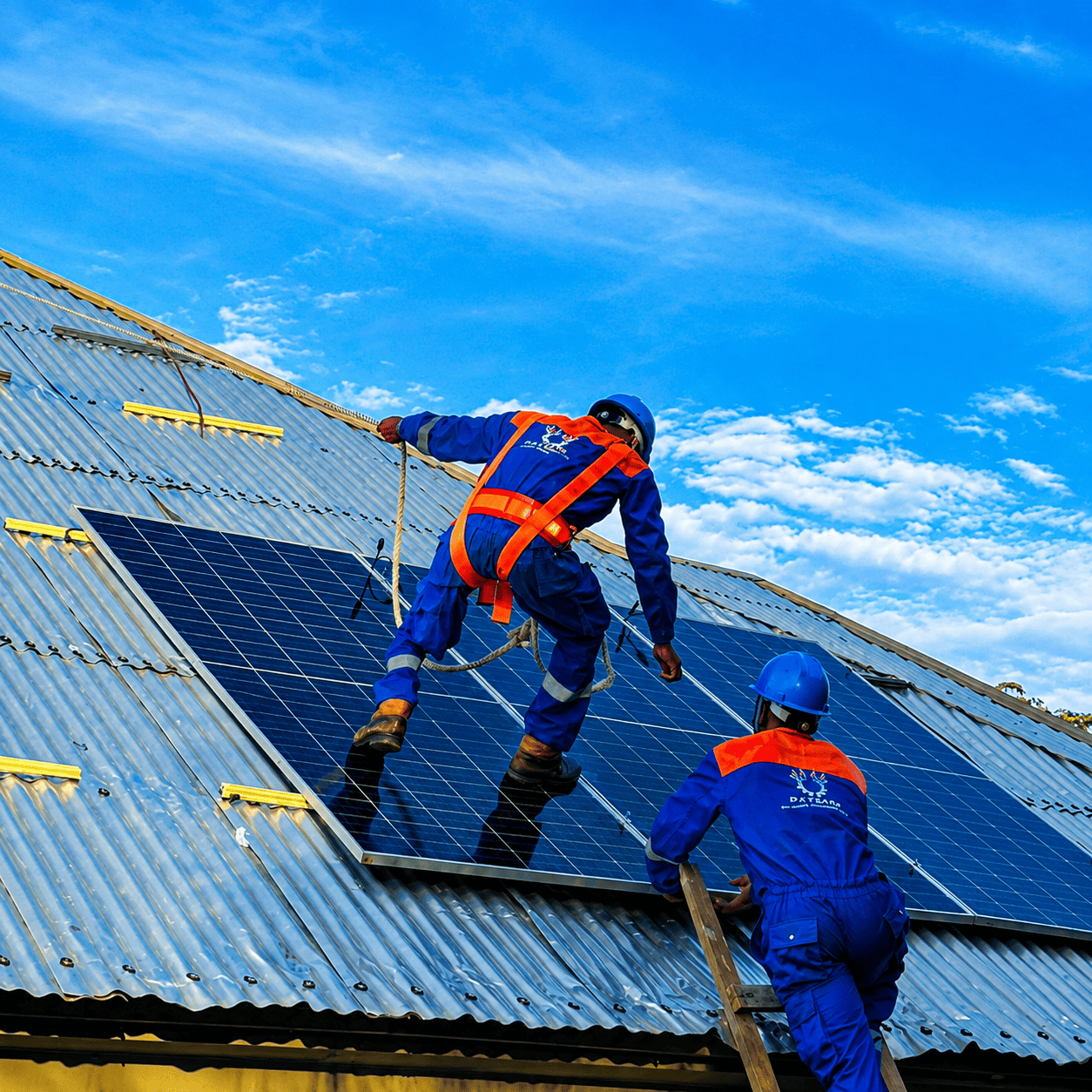 Engineers installing solar panels on a rooftop